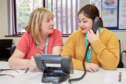 2 people talking on the telephone