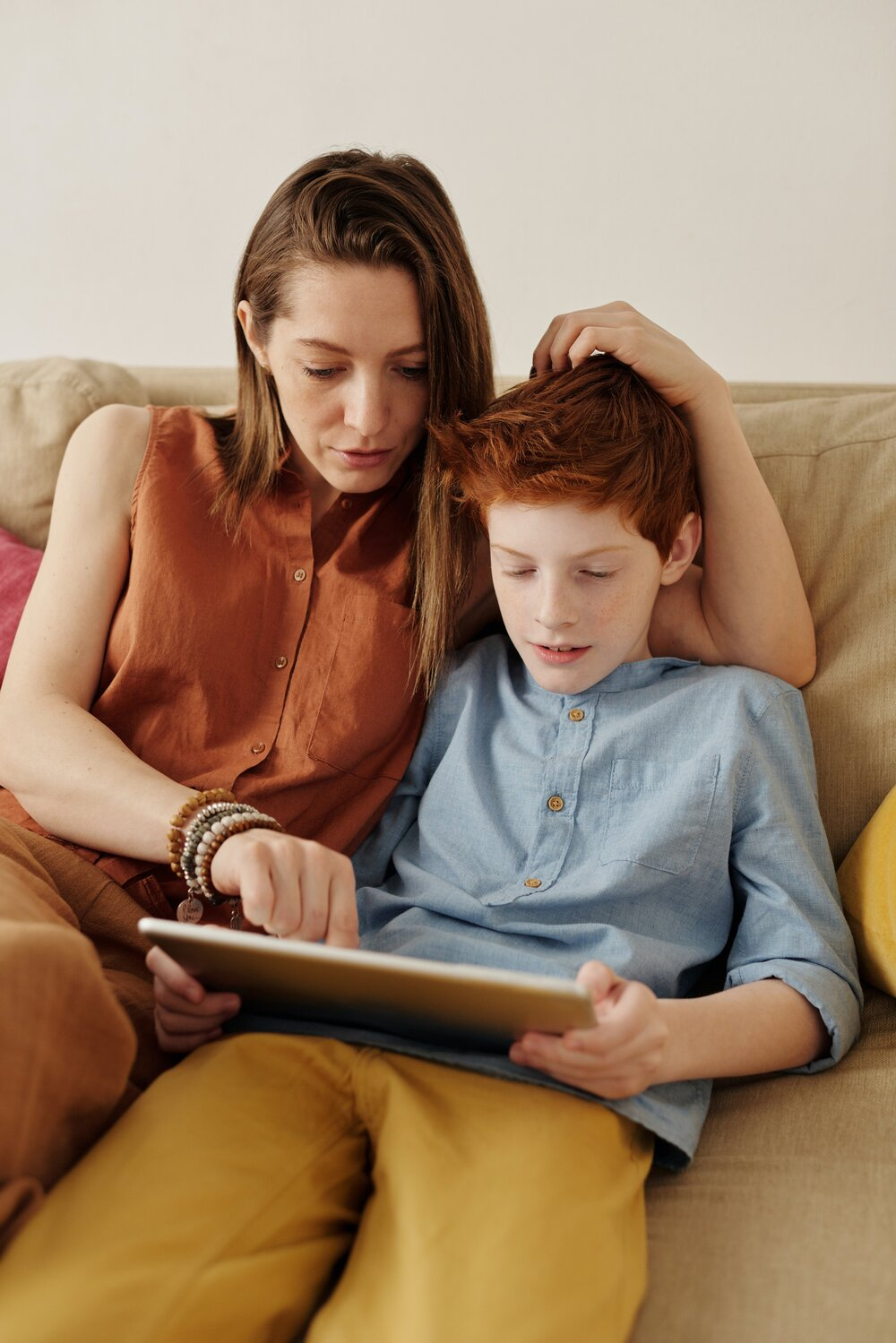 photo-of-woman-and-boy-sitting-on-couch-while-using-tablet-4145348.jpg