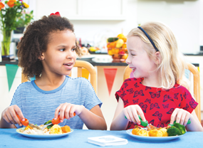 two children eating at the table.png